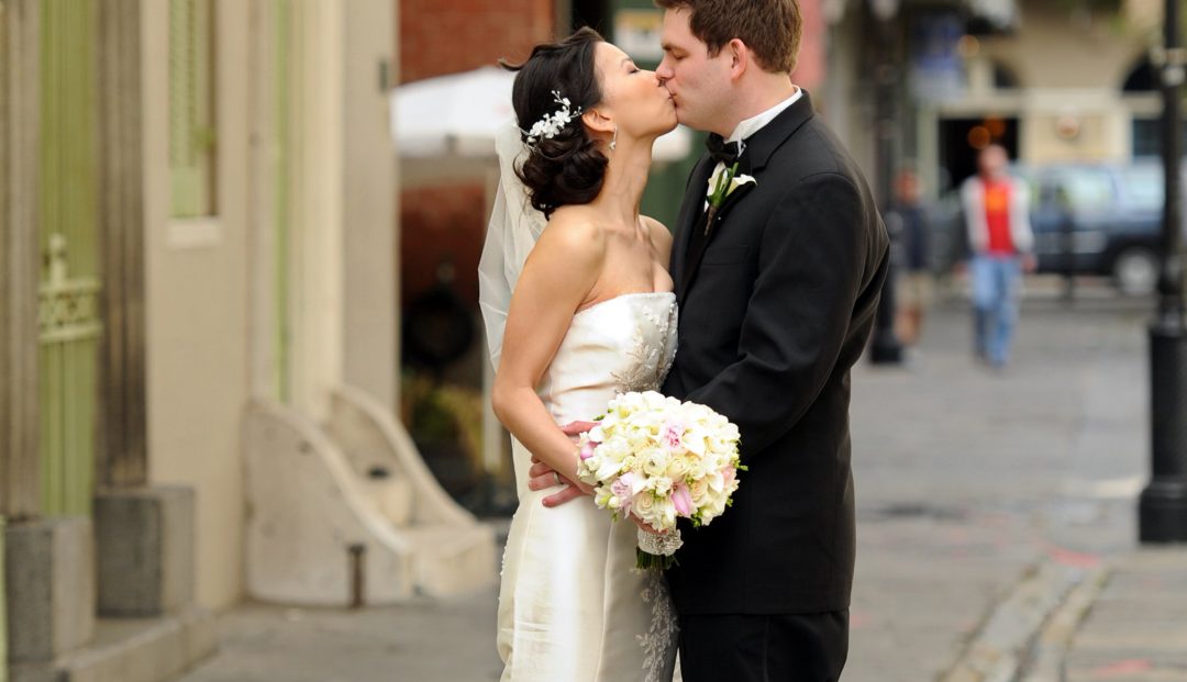 Matthew and Huyen sharing a French Quarter kiss as man and wife